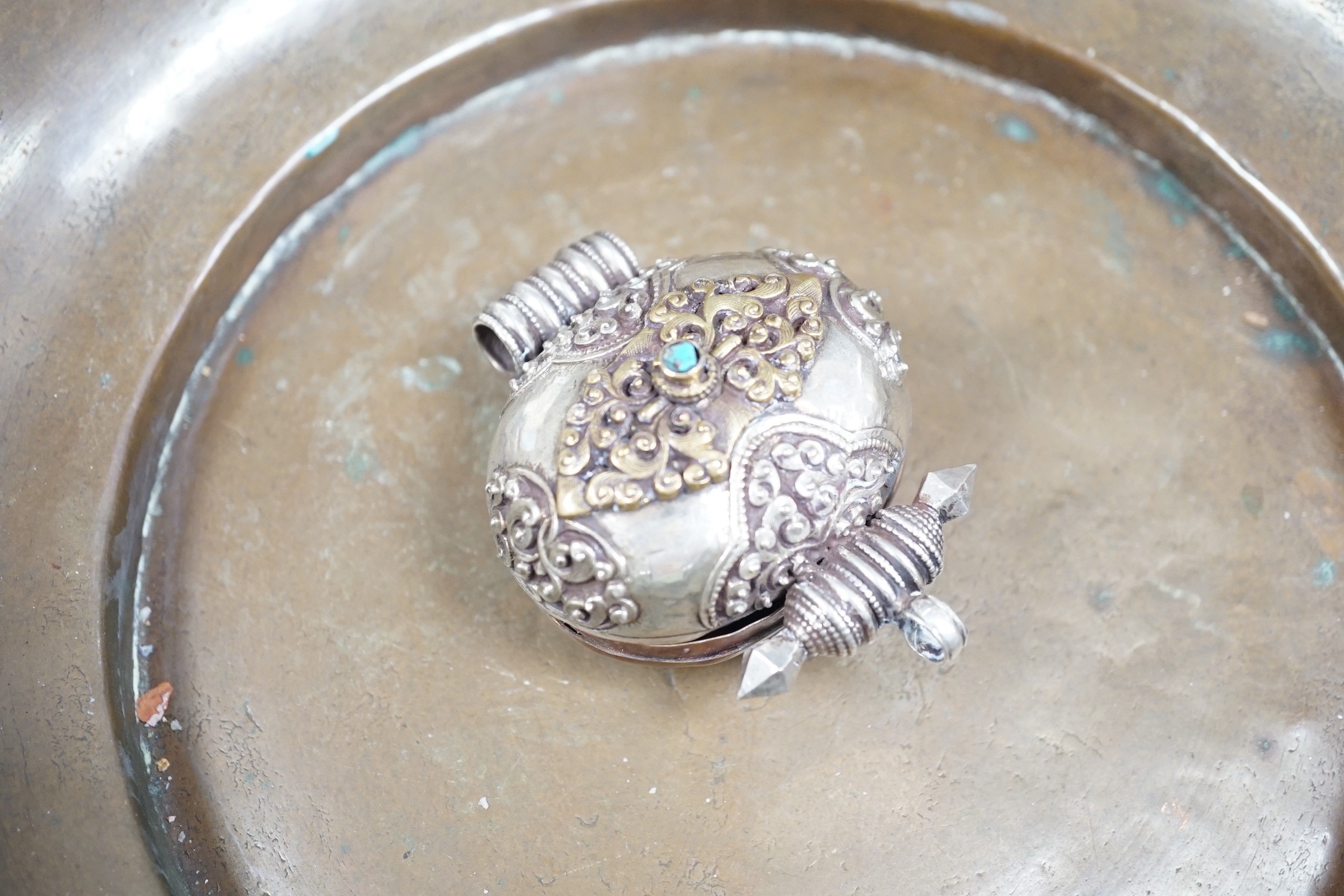 A Tibetan copper bowl and Gau, largest 28cm diameter